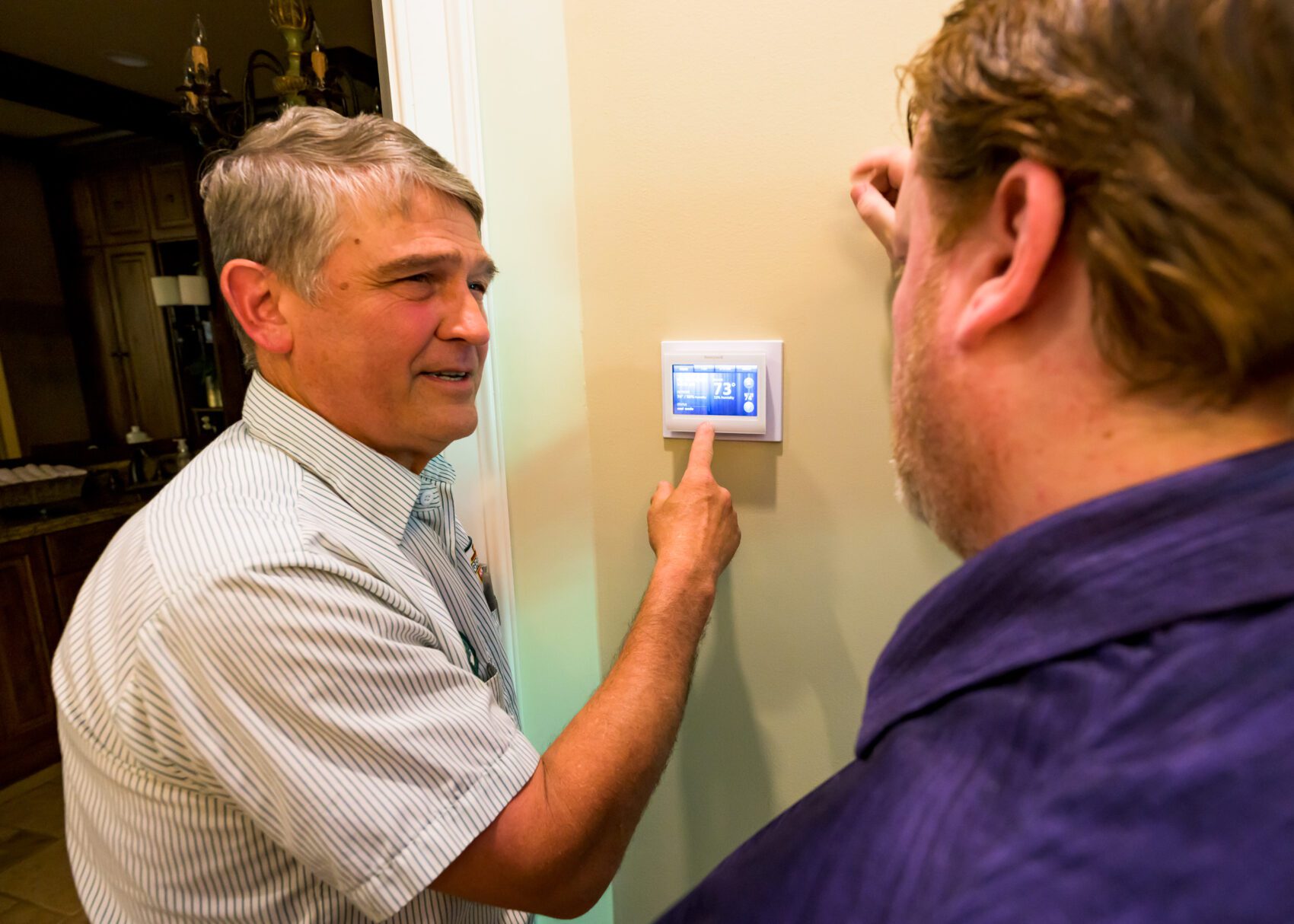 AC tech checking thermostat